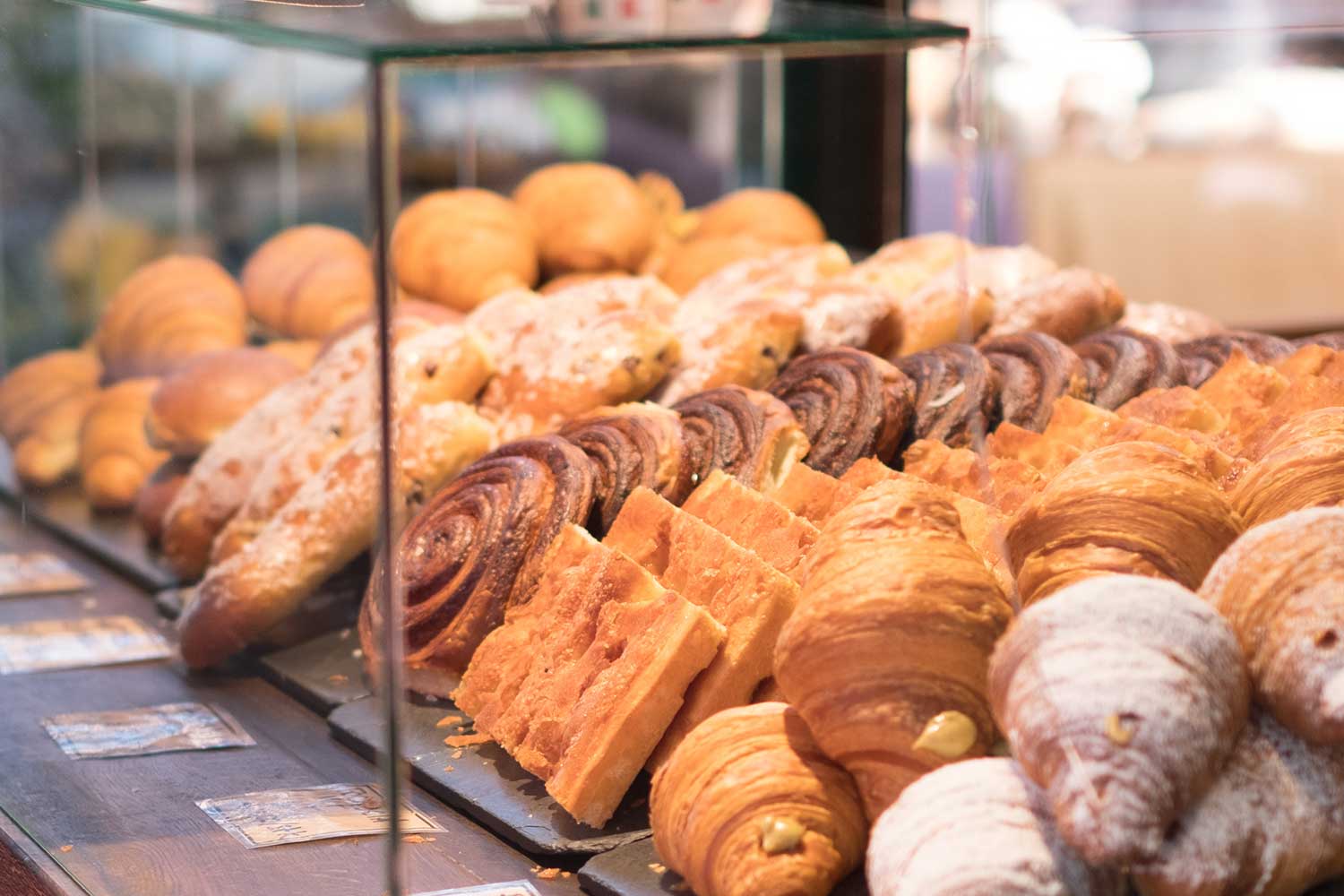 Bakery glass display of scones, pastries, and other baked goods.