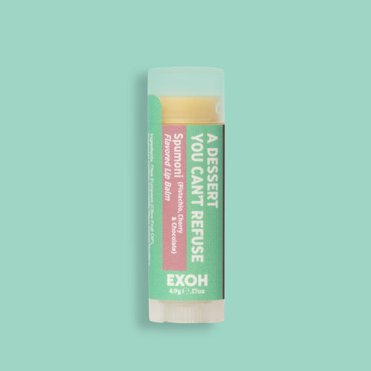 Product photo of spumoni flavored lip balm "A Dessert You Can't Refuse" by EXOH on pistachio colored background. 
