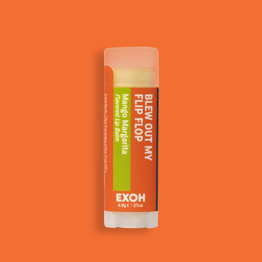 Product photo of mango margarita flavored lip balm "Blew Out My Flip Flop" by EXOH on bright orange background.