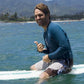 Paul Rudd's character Kunu sitting on a surfboard from the movie Forgetting Sarah Marshall.