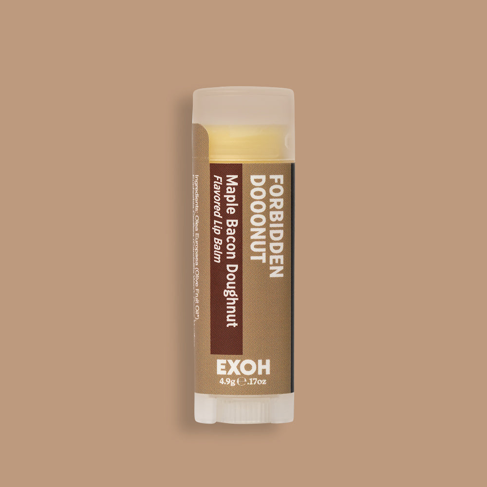 Product photo of maple bacon doughnut flavored lip balm "Forbidden Dooonut" by EXOH on maple brown background.