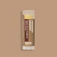 Product photo of maple bacon doughnut flavored lip balm "Forbidden Dooonut" by EXOH on maple brown background.