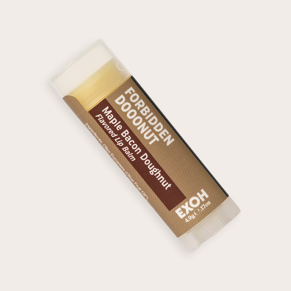 Product photo of maple bacon doughnut flavored lip balm "Forbidden Dooonut" by EXOH on grey background.