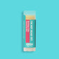 Product photo of birthday cake flavored lip balm "I'm Not Dead Yet" by EXOH on bright blue background.