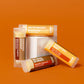 Four coffee-themed flavored lip balms by EXOH, on a burnt orange background.