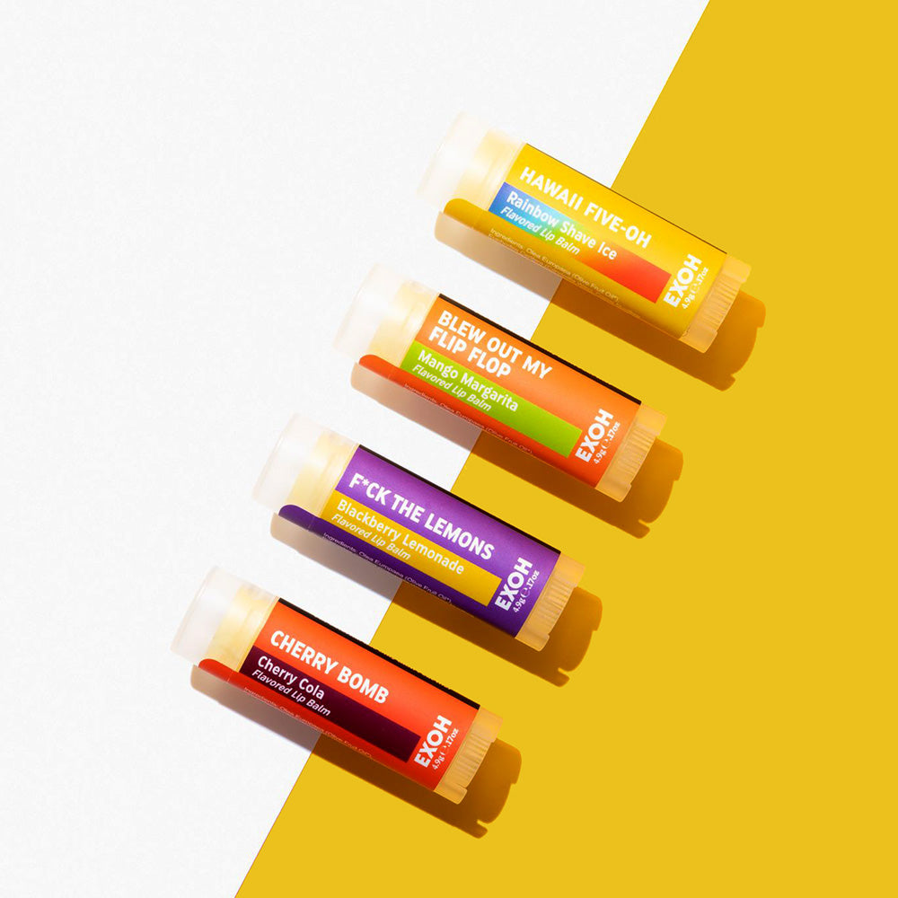 Four Summer-themed flavored lip balms by EXOH, on a yellow and white background.