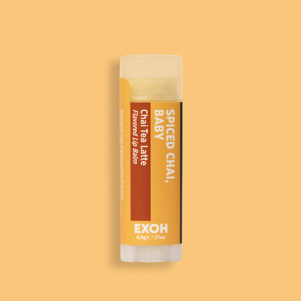 Product photo of chai tea latte flavored lip balm "Spiced Chai, Baby" by EXOH on butter yellow background.