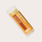 Product photo of chai tea latte flavored lip balm "Spiced Chai, Baby" by EXOH on grey background.